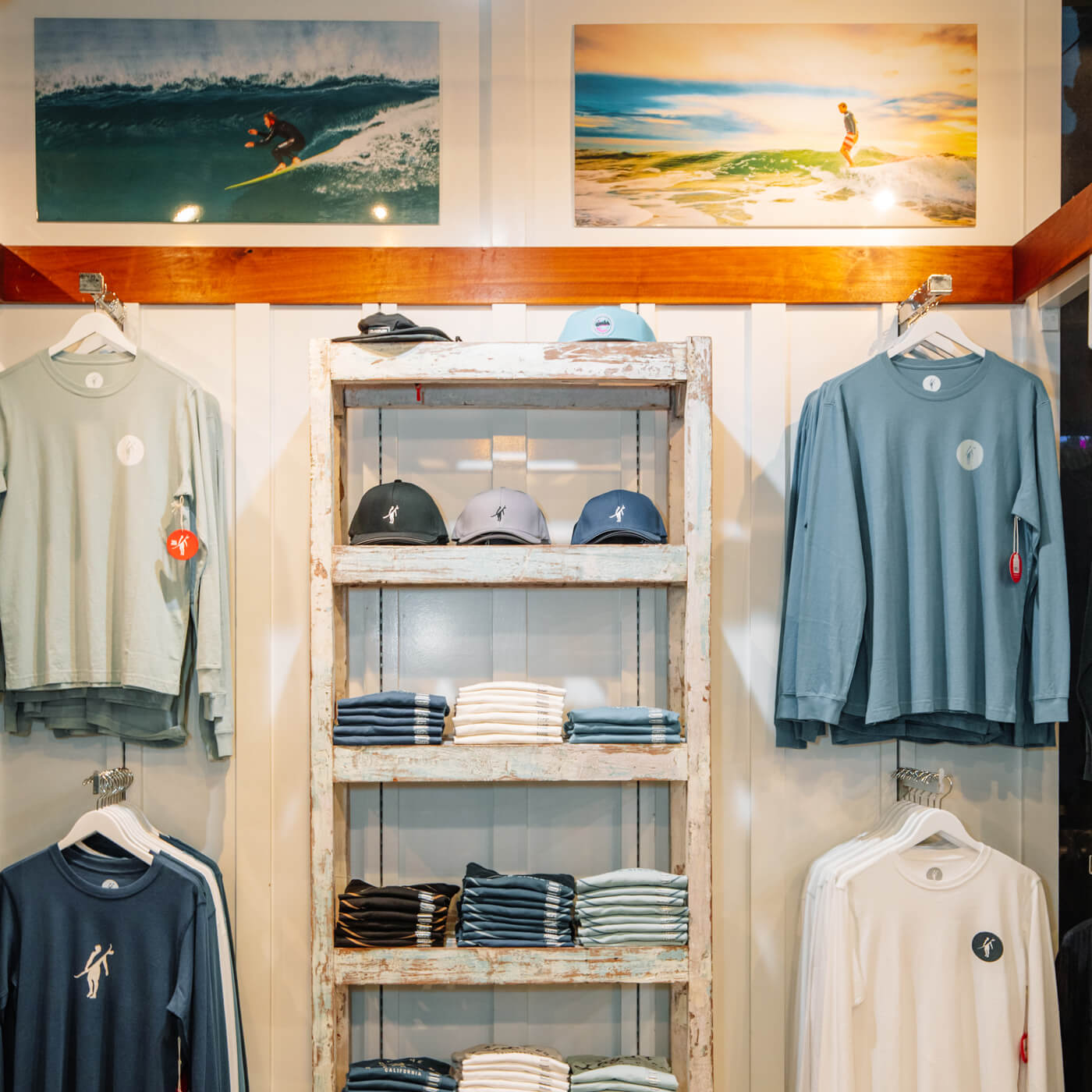 Laguna Beach retail shelves with Toes on the Nose hats, sweatshirts, and lifestyle gear