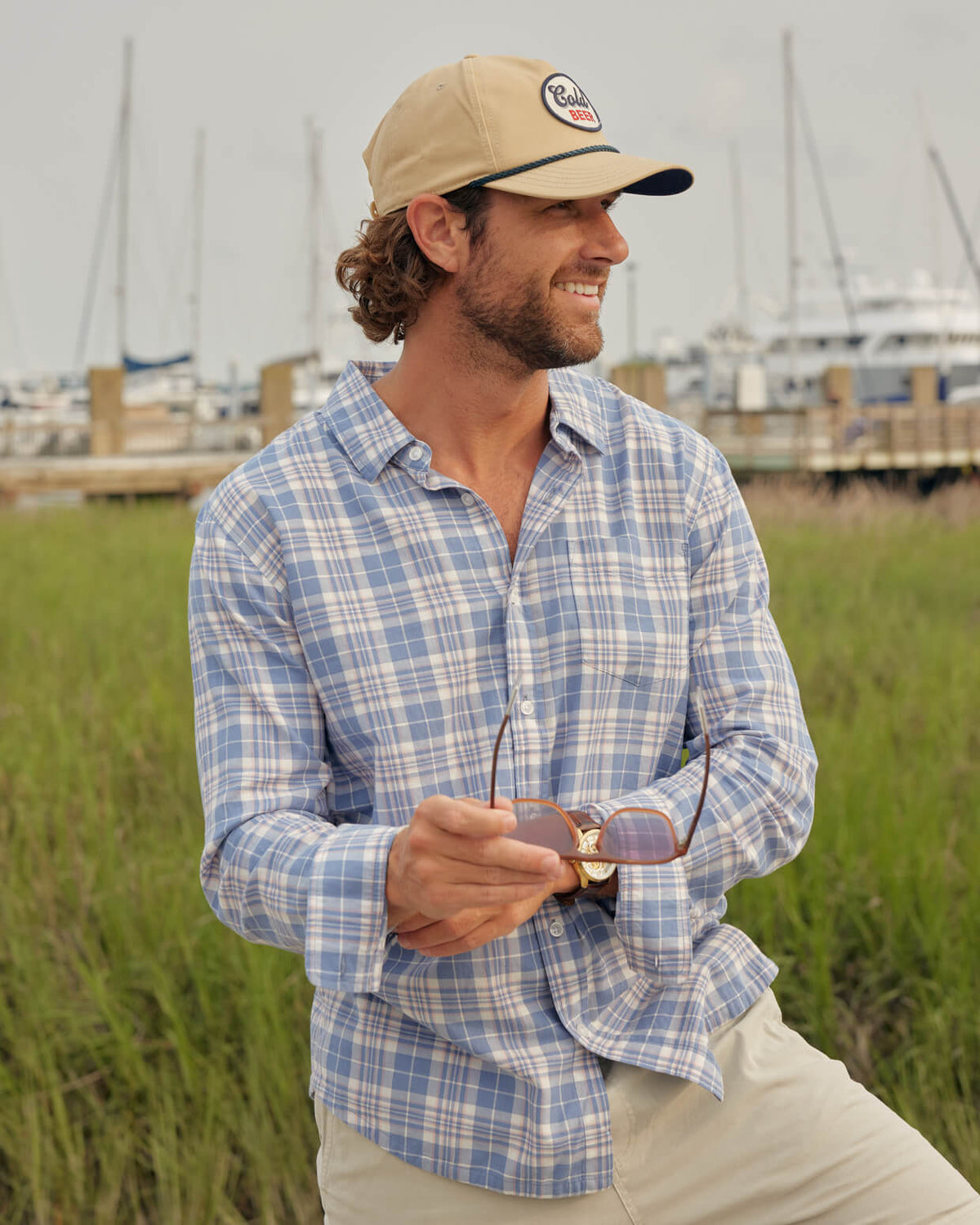 Men's blue plaid button up from Toes on the Nose, worn in a lifestyle setting outdoors. #color_bayshore blue