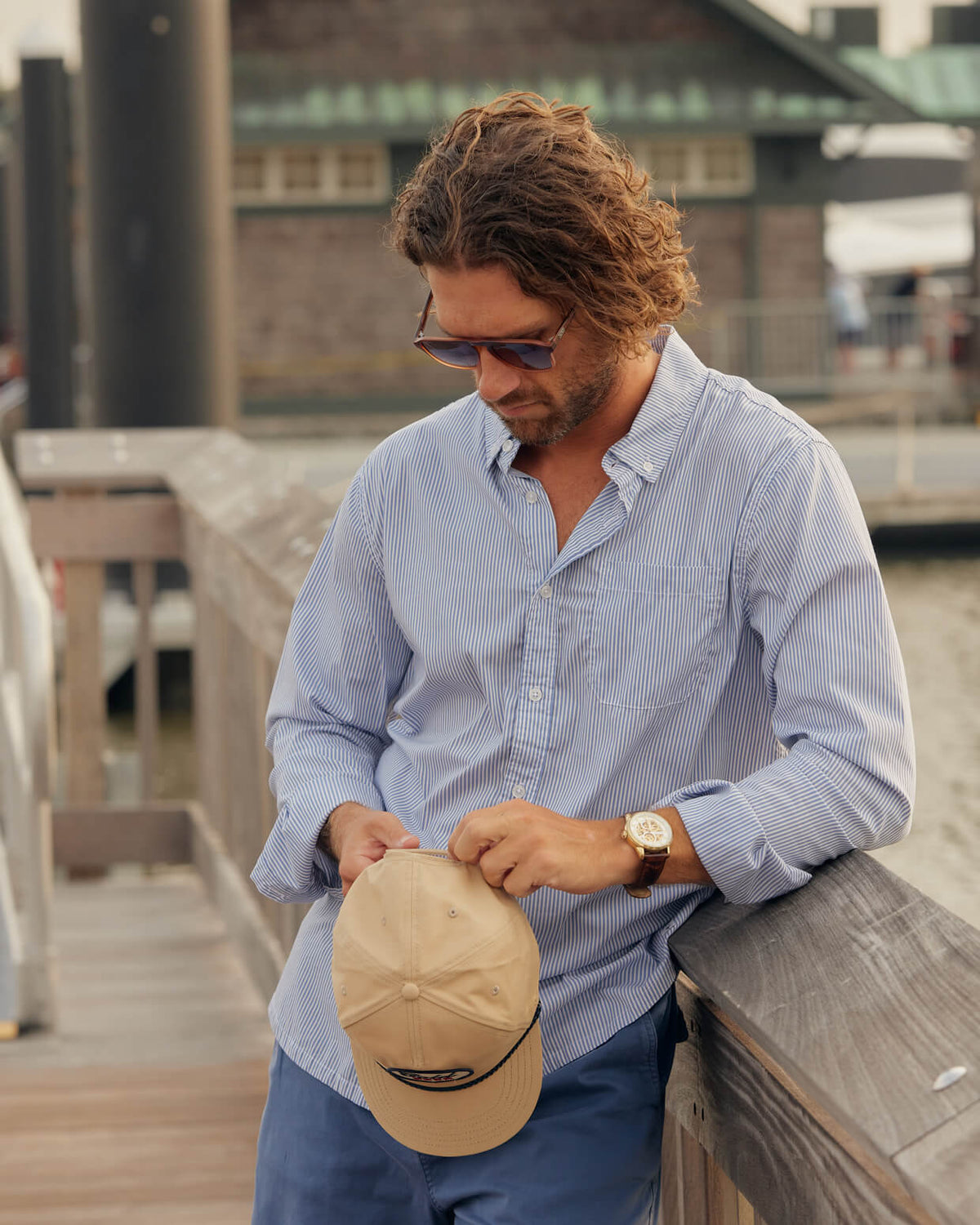 Men's blue stripe button-up from Toes on the Nose, worn in a lifestyle setting outdoors. #color_blue stripe