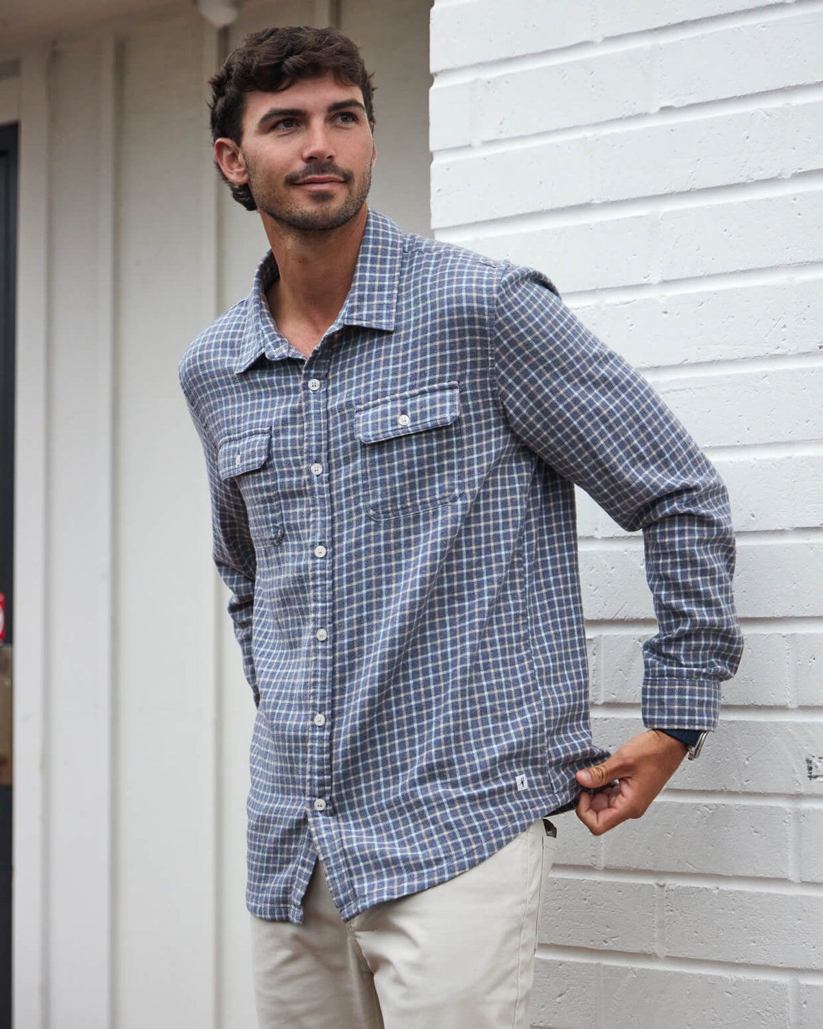 Men's grey flannel button up from Toes on the Nose, worn in a lifestyle setting outdoors. #color_grey plaid