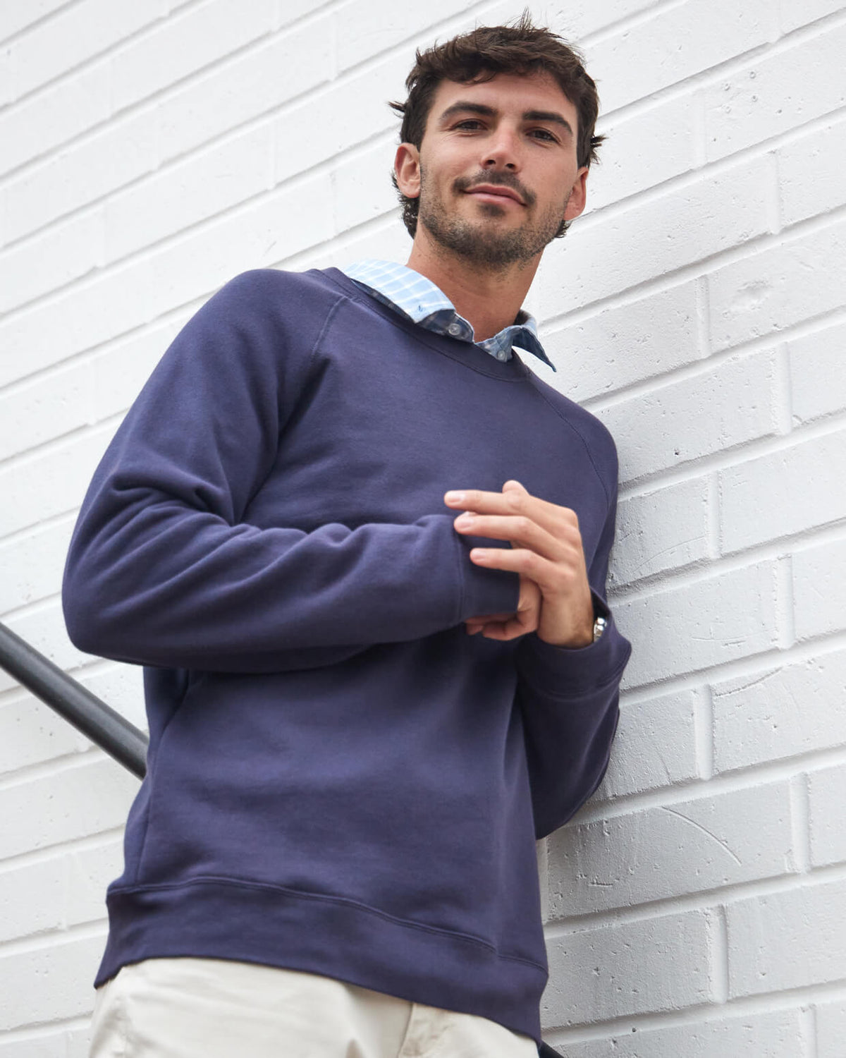 Men's navy fleece crewneck from Toes on the Nose, worn in a lifestyle setting outdoors. #color_navy