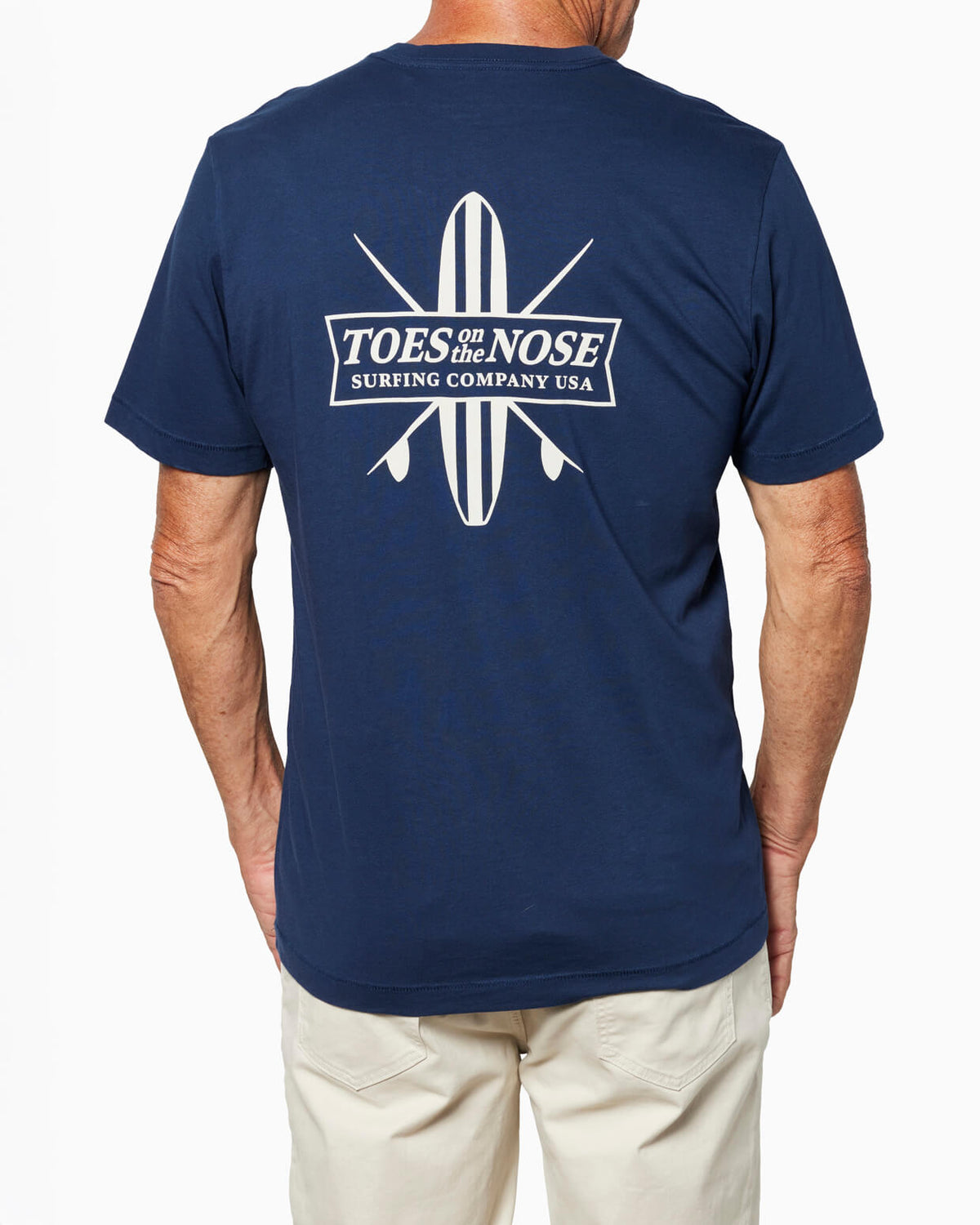 Man wearing Navy blue t-shirt with 'Toes on the Nose' logo on the back against a white background #color_navy