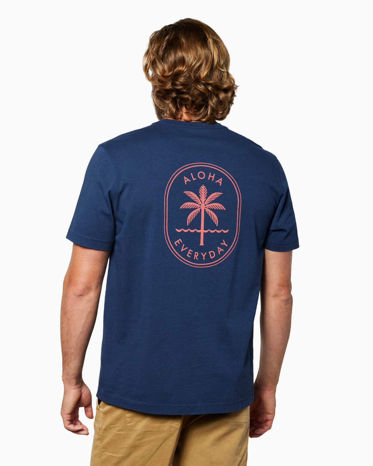 Man wearing a navy blue t-shirt with a palm tree design and 'Aloha Everyday' text on the back. #color_navy