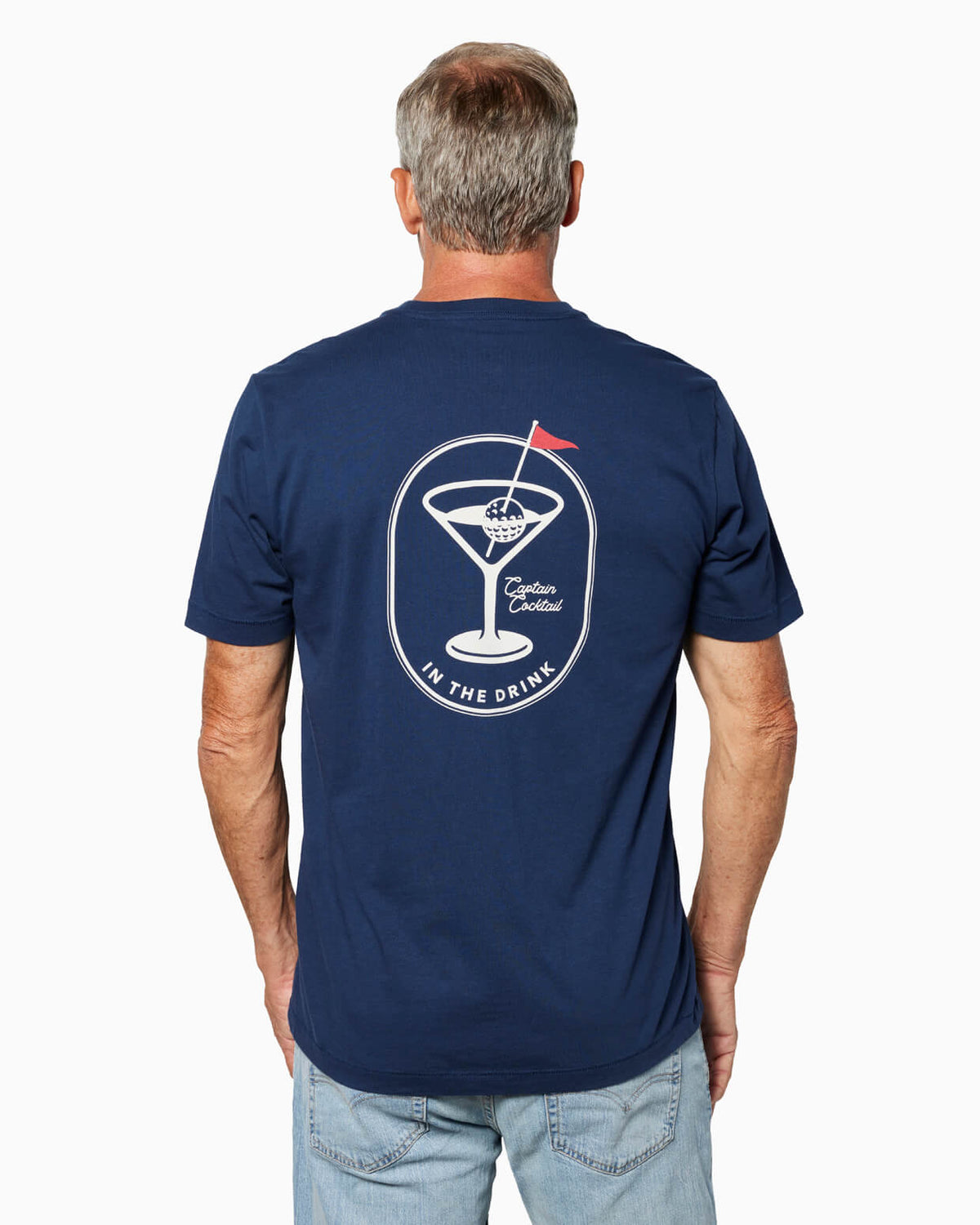Man wearing a navy blue t-shirt with a Captain Cocktail in the drink design on the back, standing against a white background. #color_navy