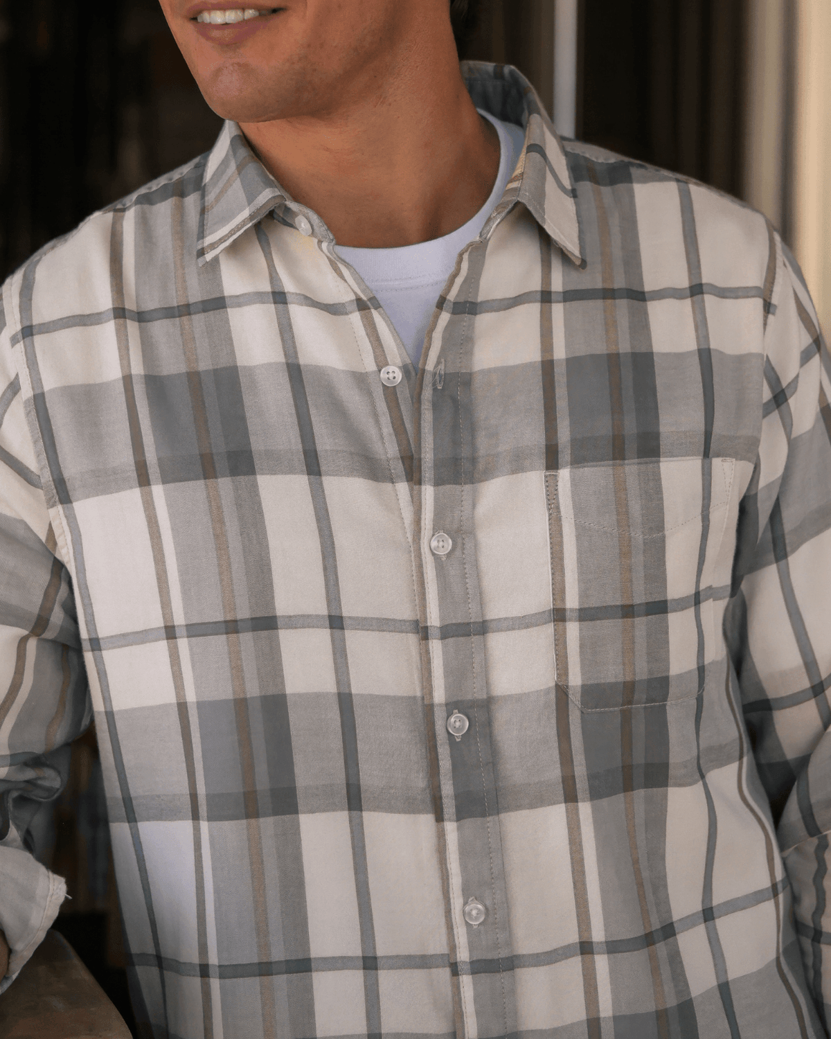 Man wearing a plaid shirt with a neutral background #color_deuce birch
