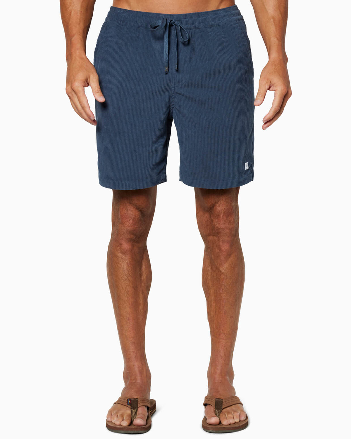 Person wearing blue shorts on a white background #color_navy cord