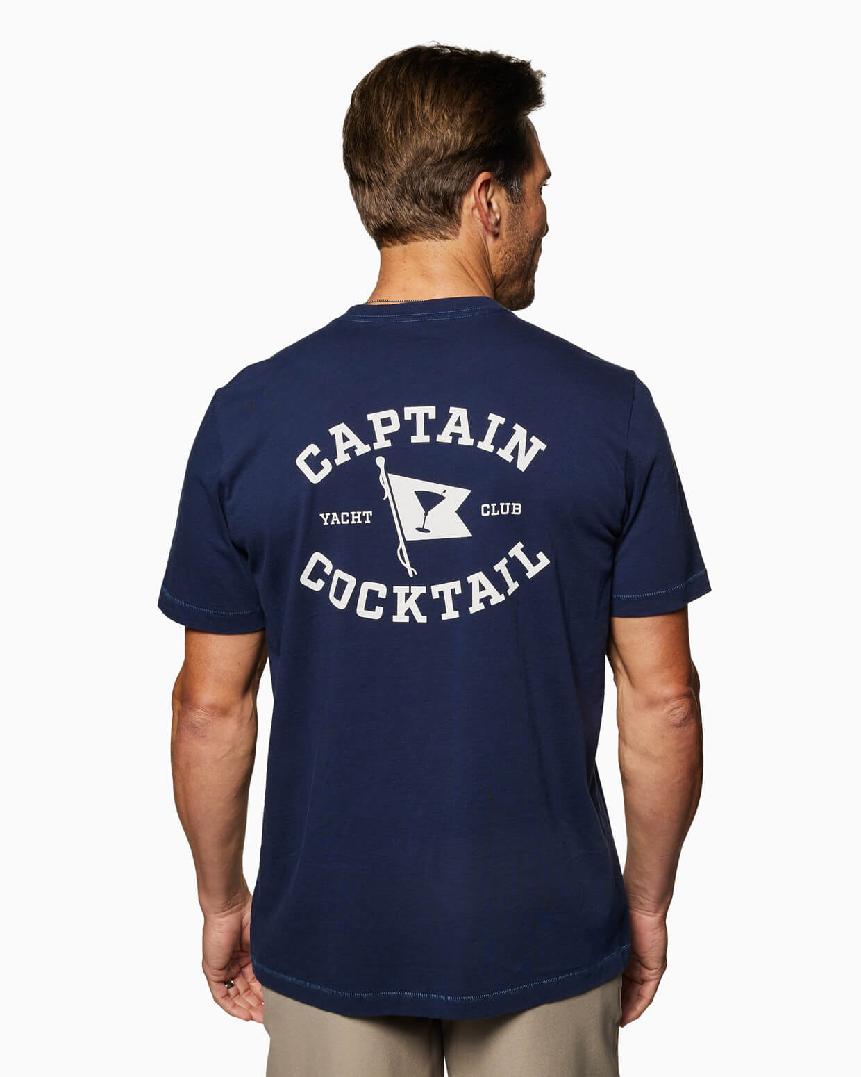 Men's navy T-shirt with Captain Cocktail Yacht Club graphic on the back, angled view.