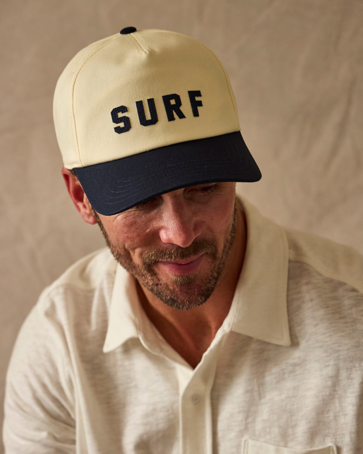 Man wearing SURF hat against white background #color_navy surf