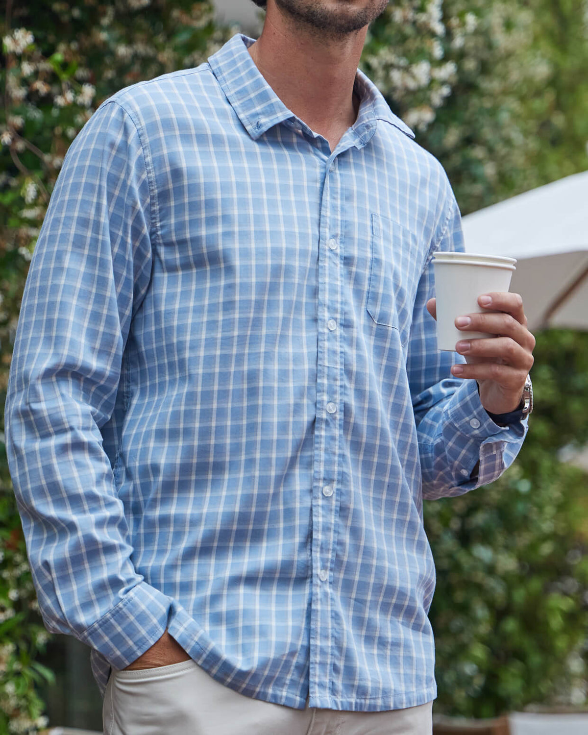 Men's blue plaid button up from Toes on the Nose, worn in a lifestyle setting outdoors. #color_blue plaid