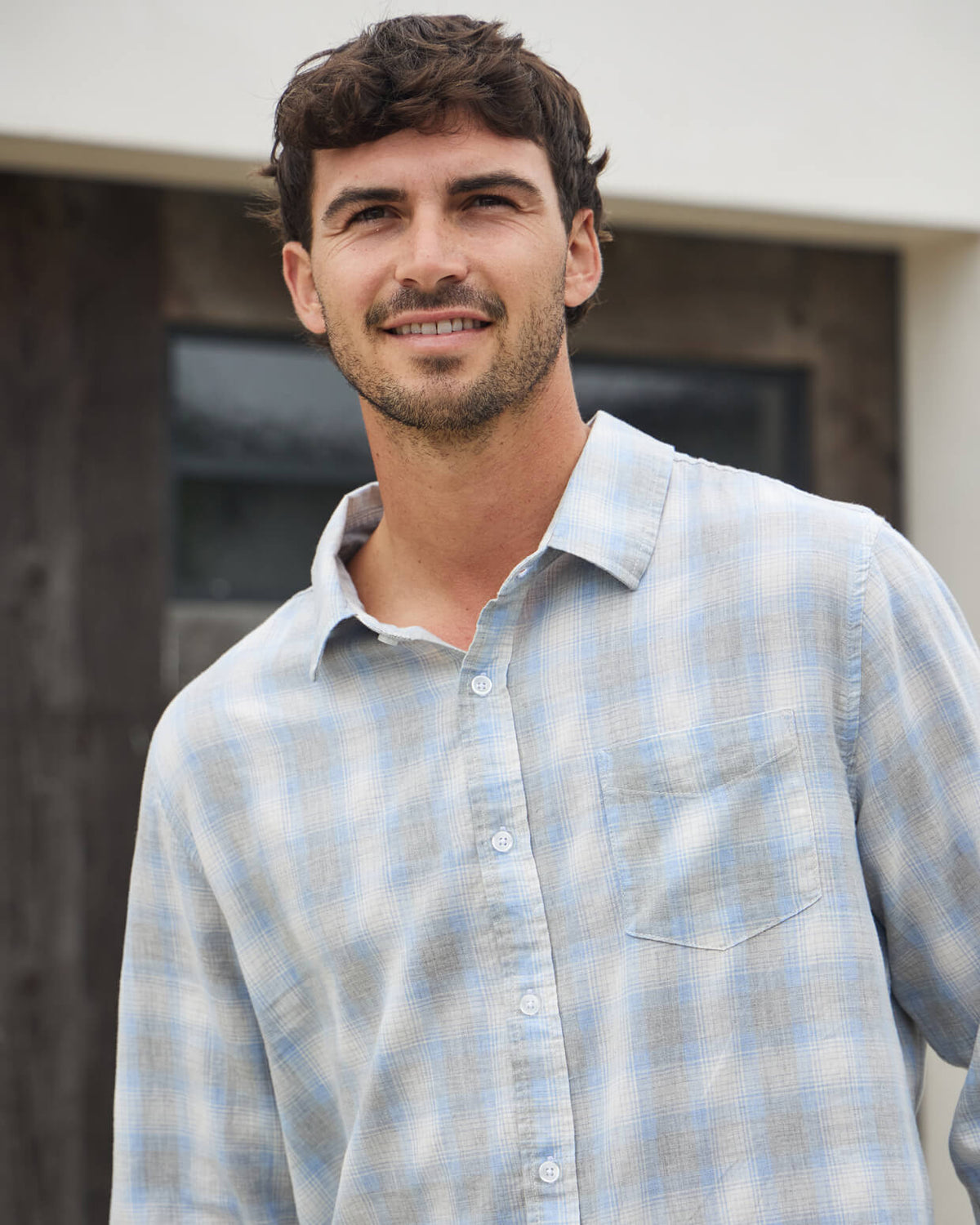 Men's heather grey button up from Toes on the Nose, worn in a lifestyle setting outdoors. #color_heather grey plaid
