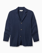 A navy blue textured knit cardigan sweater with notch lapels, three buttons, and front patch pockets, displayed on a clean white background. #color_eastate navy