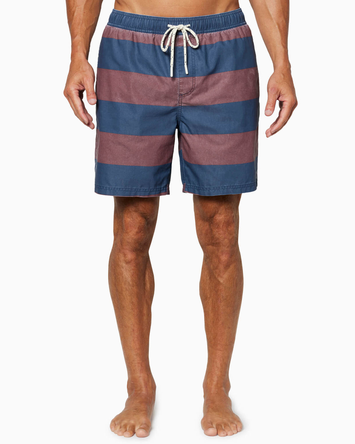 Person wearing blue and red striped swim shorts on a white background #color_navy classic stripe