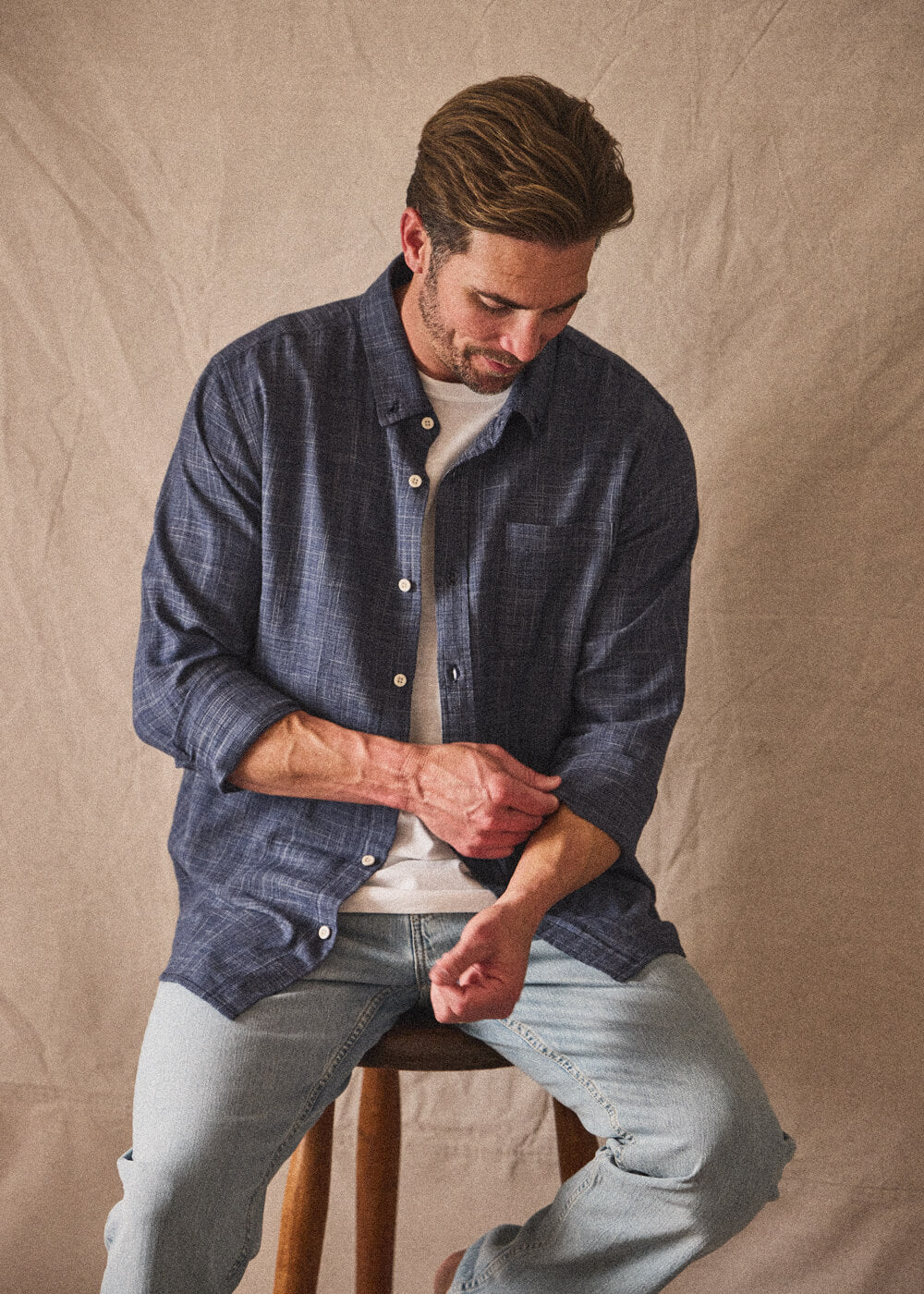 Man wearing a navy button-up with canvas background showcasing style of Toes on the Nose new arrivals in mobile view