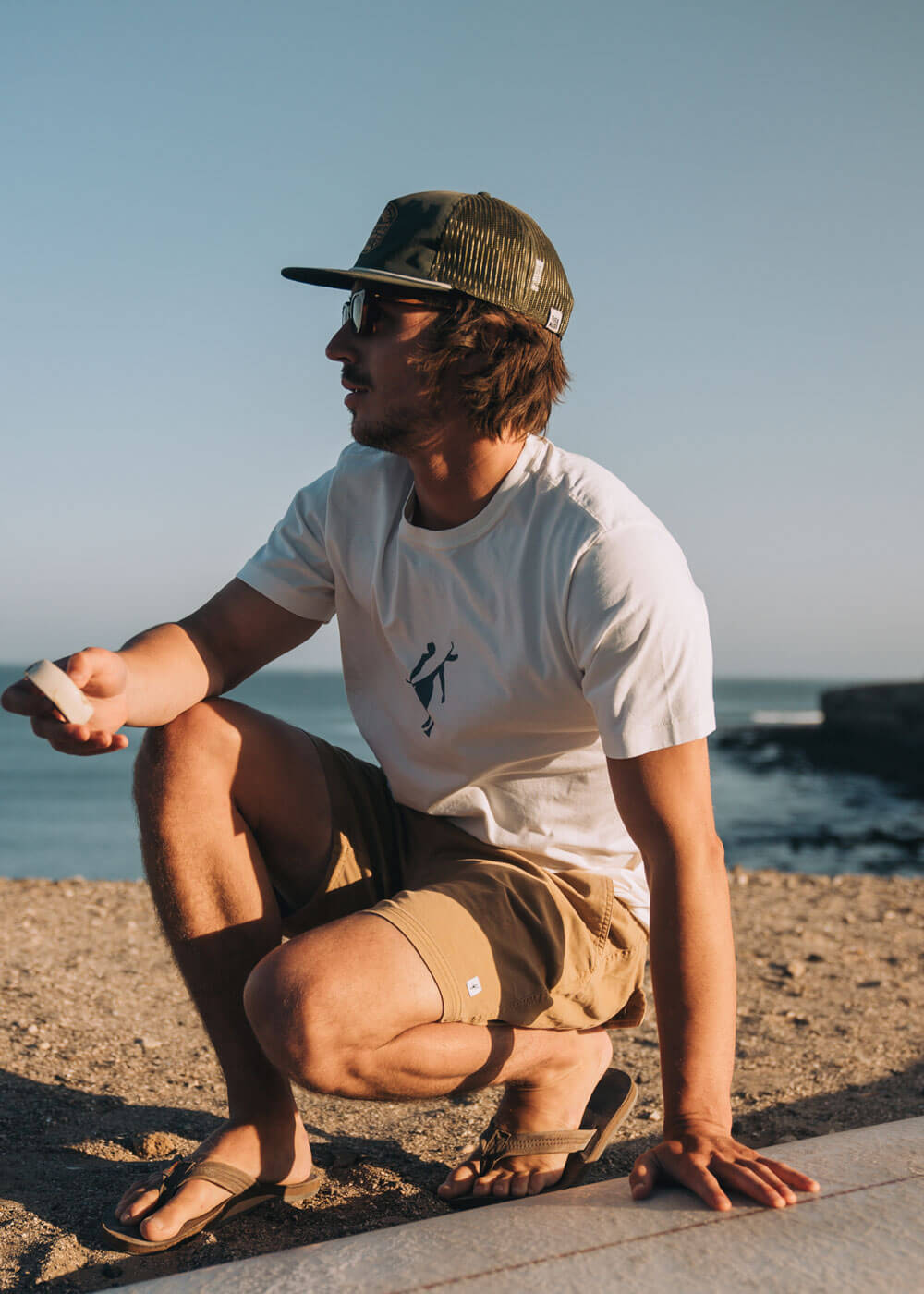 Men's t-shirt and hat displayed on mobile view, showcasing the front design.