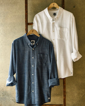 Mens long sleeve button-ups hanging on ladder

